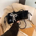 Black glossy underarm bag featuring an elegant pearl bow charm accessory - With Pearl Bow Pendant Style / Black