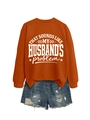 Detail of orange crewneck sweatshirt with slogan and distressed denim shorts on white background - Burnt Orange (White Font)