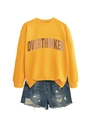 Close-up of Overthinker print on yellow crewneck sweatshirt with distressed denim shorts - Yellow