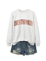 Flat lay of OVERTHINKER grey sweatshirt with distressed blue denim shorts set - Off-White