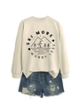 Detail of Ski More Worry Less print on beige sweatshirt with distressed denim shorts - Sand (Black Font)