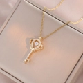 Sparkling crown heart key necklace with moving center stone in gold finish - Gold Crown Key Necklace (X3588)