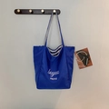 Minimalist blue canvas tote bag with white lettering and striped lining detail - Blue B-Side (Letter Print)