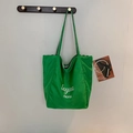 Neon green striped tote bag with lettering and checkerboard lining on wall hanger - Green B-Side (Letter Print)