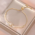 Elegant gold celestial bracelet with moon sun pendant and zircon stones on box chain - Rotating Flower Bracelet (TS0243) / Gold