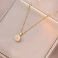 Golden rotating flower necklace with light opal petals and white cubic zirconia accents - Cat Eye Stone Rotating Necklace (X1610)