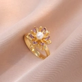 Detailed close-up of a floral ring with white pearl and purple zircon on champagne silk - Purple Gold Daisy Ring