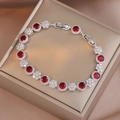 Elegant silver bracelet featuring round red emerald stones and white zircon floral accents - Red and White (TS0341)