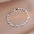 Detailed macro view of silver floral bracelet with sparkling emerald cut cubic zirconia - Transparent White (TS0334)