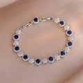 Macro detail of royal blue crystal bracelet with pave zircon flowers on silk fabric - Royal Blue (TS0331)