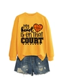 Detail of orange sweatshirt with My Heart is on That Court basketball print and denim shorts - S / Tops / Yellow