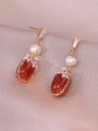 Detailed close-up of vintage earrings with red agate pendants and white flower accents - Earrings (E1198) / Red