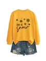 Detailed view of yellow let it snow sweatshirt paired with distressed denim shorts - Yellow (Black Print)