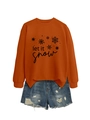 Detail of orange crewneck sweatshirt with black let it snow text and snowflake print - Burnt Orange (Black Print)