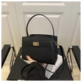 Detail of black Saffiano leather crossbody bag with golden turn-lock and sturdy handle - Black