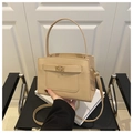 Detail of minimalist beige handbag showing cross-grain leather and golden turn-lock - Khaki