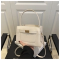 Detail of cream Saffiano tote bag with gold twist lock and structured cross-body strap - White