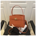 Detail of orange Saffiano leather handbag with gold twist lock and rounded top handle - Orange