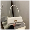 Macro detail of white crocodile-embossed faux leather bag and polished gold buckle - White