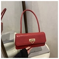 Detail of red woven leather handbag with gold D-ring buckle in a vintage aesthetic - Red