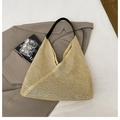 Detail of woven straw shoulder bag with brown leather straps on a beige blazer - Brown