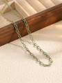 Golden stainless steel chain necklace with sky blue enamel links on white marble - Blue