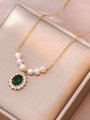 Detailed view of emerald zircon flower pendant with freshwater pearls on a gold necklace - Dark Green Gemstone Pearl Necklace (X3678)