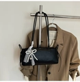 Detail of black leather shoulder bag featuring white lace bow and pearl heart pendant - Black with Pendant