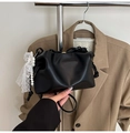 Detail of black pleated cloud bag featuring pearl charms and delicate lace trim - With Charm / Black
