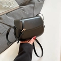 Minimalist black saddle crossbody bag with smooth leather finish and gold metal hardware - Black