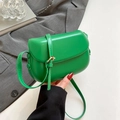 Vibrant green crossbody saddle bag with golden metal buckle and slender shoulder strap - Green