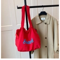 Red large capacity canvas tote bag with blue Beach lettering and drawstring closure - Red