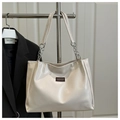 Detail of cream tote bag featuring silver chain strap and polished leather texture - No Pendant / White