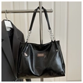 Detail of black patent leather tote bag with silver chain strap and leather logo tag - No Pendant / Black