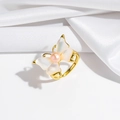 Detail of a butterfly ring with white shell wings and a pink pearl on gold base - Ring