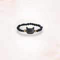 Macro shot of handcrafted black spinel ring with cat-shaped stone and gold beads - Black Cat Style
