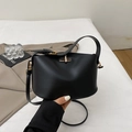 Minimalist black matte leather bucket bag with gold twist lock and shoulder strap - Black