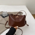 Dark brown bucket handbag with gold twist lock and adjustable shoulder strap - Brown