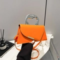 Modern bright orange handbag with silver metal handle and asymmetrical flap closure - Orange