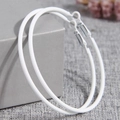 Minimalist large white hoop earrings with matte finish shown on a gray display box - White