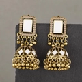 Vintage Middle Eastern gold Jhumka bell earrings with white enamel on grey stone display - Bronze White