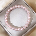 Elegant 8mm pink pearl stretch bracelet presented on silk fabric for a stylish look - Pink