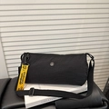 Minimalist black cylinder crossbody bag with neon yellow strap and adjustable belt - Black