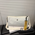 White nylon shoulder bag featuring a yellow decorative strap and adjustable textile strap - White