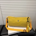Vibrant yellow nylon crossbody bag with textured fabric and decorative ribbon strap - Yellow