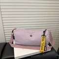 Lavender cylindrical shoulder bag with woven strap and yellow hanging ribbon - Purple