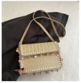 Detail of woven straw crossbody bag with shell pendants and braided lace trim - Khaki