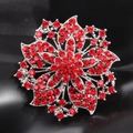 Detailed macro view of the silver flower brooch with vibrant red crystal pavé petals - Red