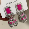 Detailed shot of ethnic silver jhumka earrings with pink enamel and bell pendants - Antique Silver Rose Red