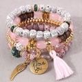 Set di 4 bracciali boho multistrato con perline, ciondoli ad ala e nappa rosa elegante - Rosa